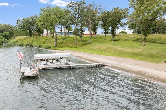 view of dock with a water view and a lawn