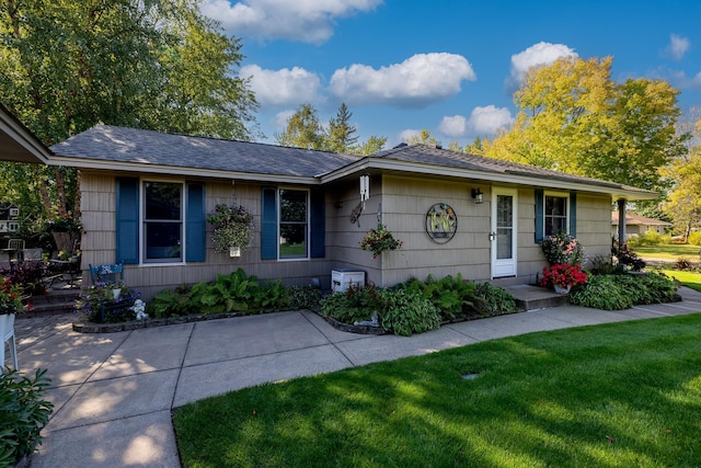 ranch-style home with a front lawn