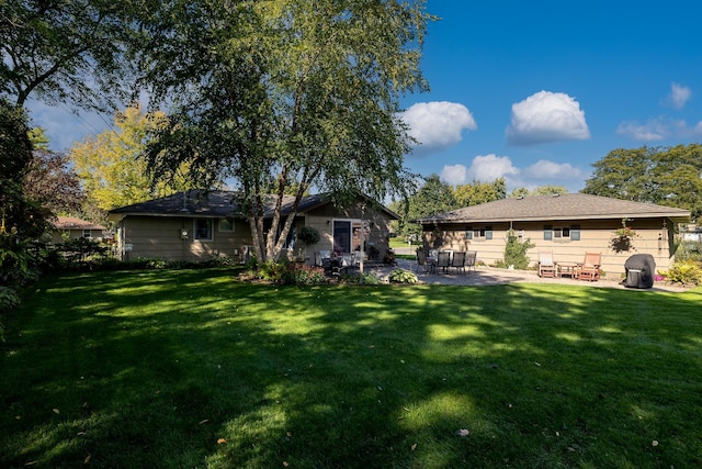 back of property with a patio and a lawn