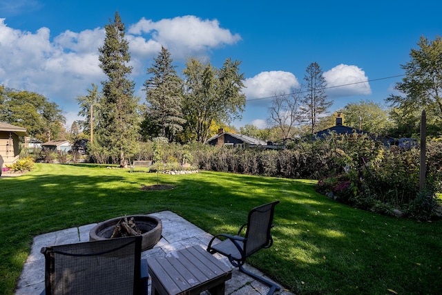 view of yard with a patio area and a fire pit