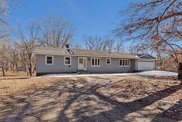 ranch-style house featuring a garage and driveway