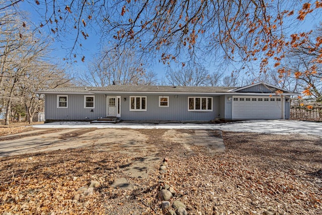 ranch-style home featuring a garage and driveway