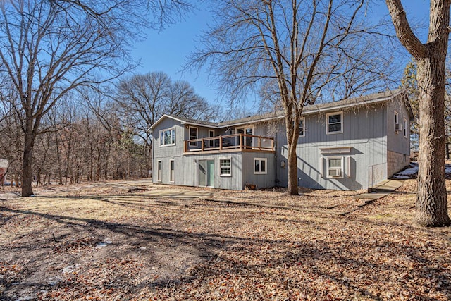 rear view of property with cooling unit and a deck