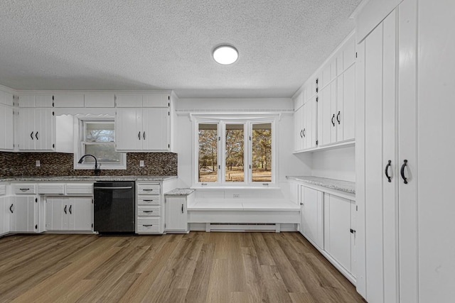 kitchen with a baseboard radiator, light wood-style floors, dishwasher, and white cabinets