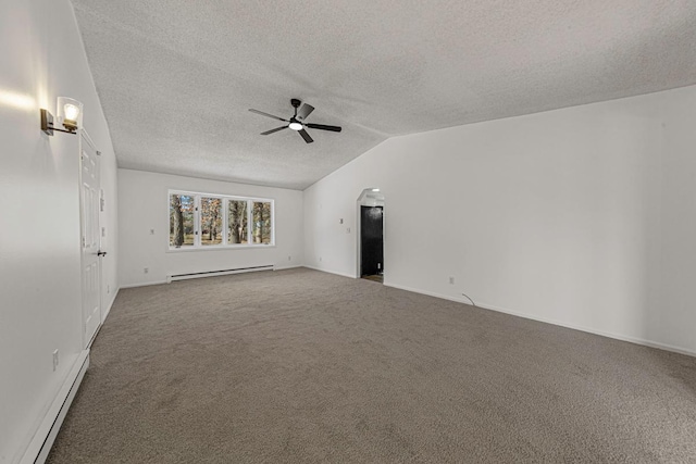 spare room featuring lofted ceiling, carpet flooring, baseboard heating, and ceiling fan