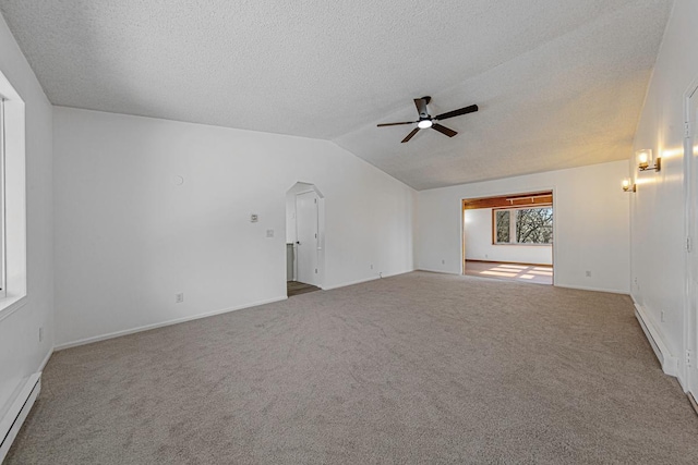 carpeted spare room featuring a baseboard heating unit, a textured ceiling, ceiling fan, and vaulted ceiling