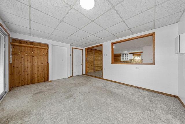 interior space with baseboards and a drop ceiling