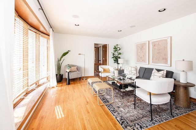 living area featuring recessed lighting, light wood-type flooring, and baseboards