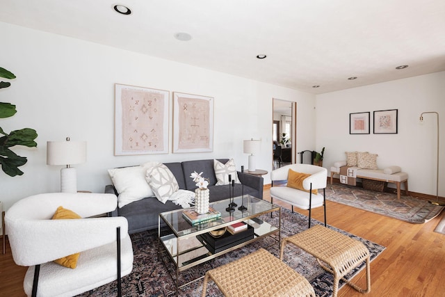 living area featuring recessed lighting, baseboards, and wood finished floors