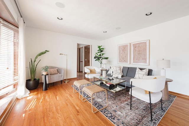 living area featuring recessed lighting, baseboards, and light wood-style floors