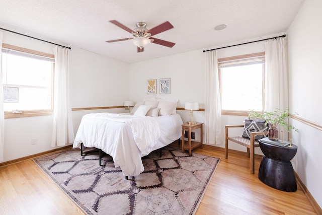 bedroom with light wood-style floors and baseboards