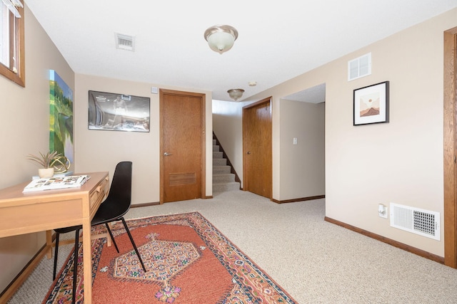 office space with carpet, visible vents, and baseboards