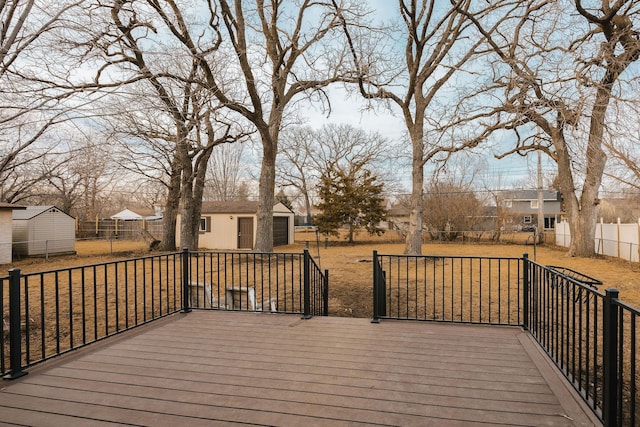 wooden deck featuring an outbuilding, fence, and a residential view