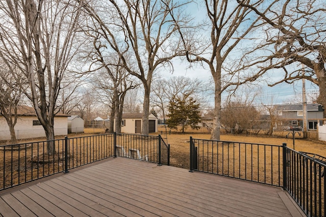 wooden deck with an outbuilding, a residential view, and fence