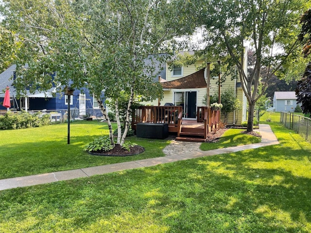 view of yard featuring fence and a wooden deck