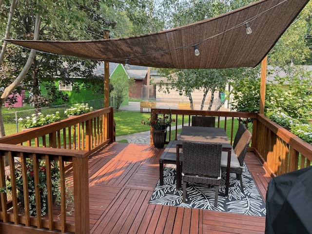 deck featuring grilling area, outdoor dining area, and fence