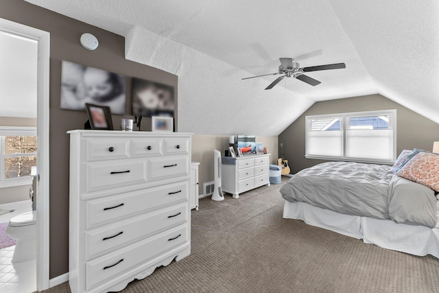 carpeted bedroom with baseboards, ceiling fan, a textured ceiling, and lofted ceiling