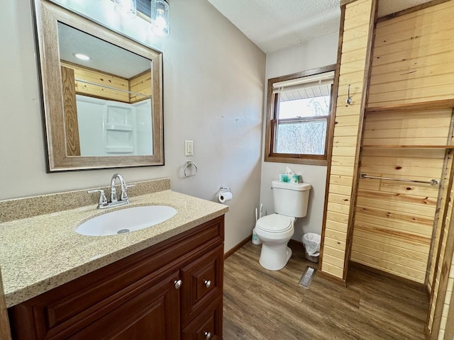 28887 Hi Vista Dr, Otter Tail Twp, MN 56515 - bathroom featuring wood finished floors, vanity, toilet, baseboards, and a textured ceiling