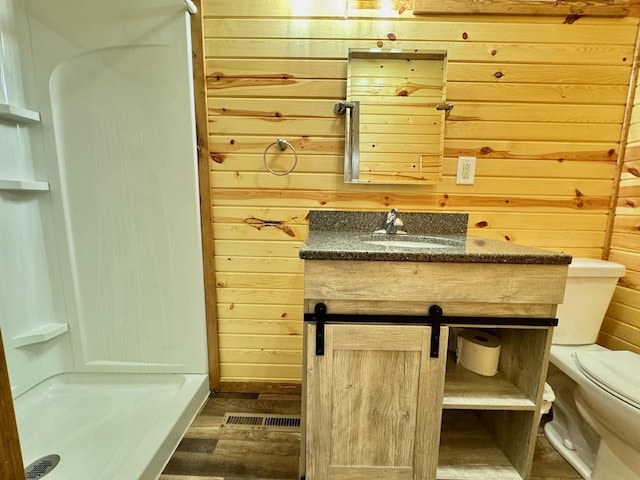 28887 Hi Vista Dr, Otter Tail Twp, MN 56515 - bathroom featuring wood walls, toilet, a shower stall, wood finished floors, and vanity