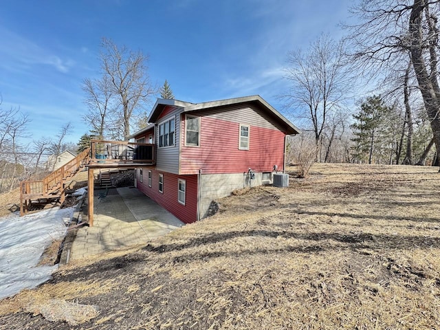 28887 Hi Vista Dr, Otter Tail Twp, MN 56515 - view of home's exterior featuring a deck, cooling unit, and stairs