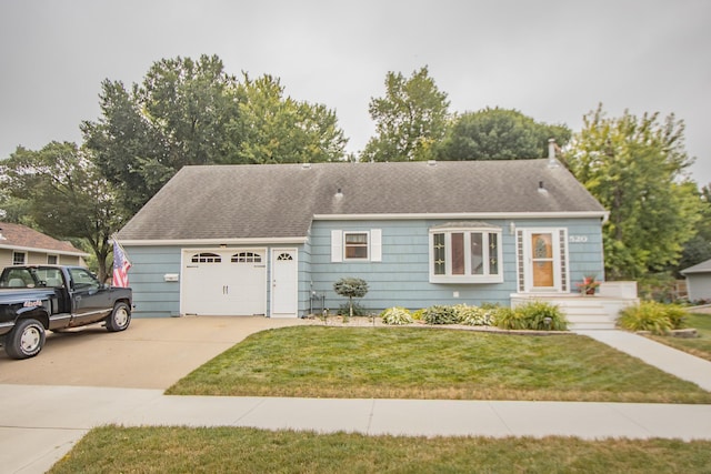 single story home with a front lawn, roof with shingles, concrete driveway, and an attached garage