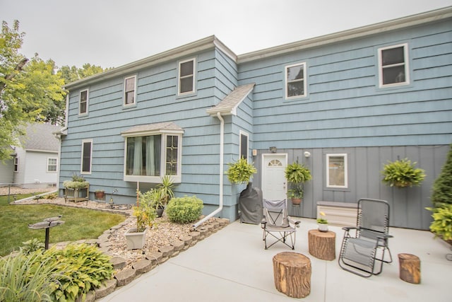 back of property with a patio and a yard