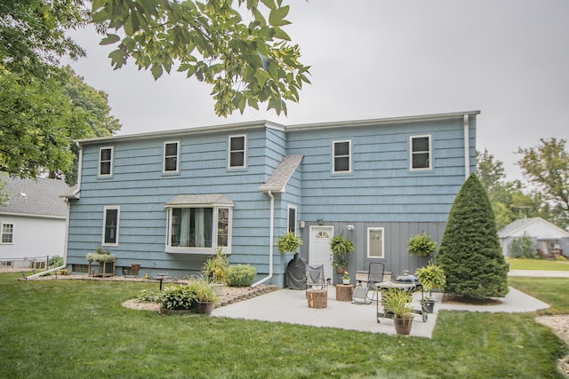 back of property with a patio and a yard