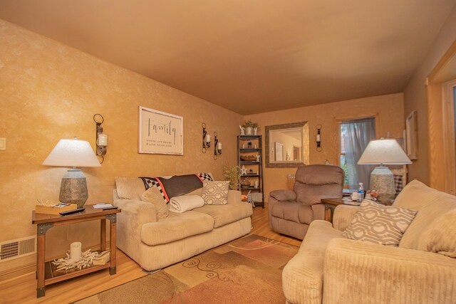 living room featuring visible vents and wood finished floors