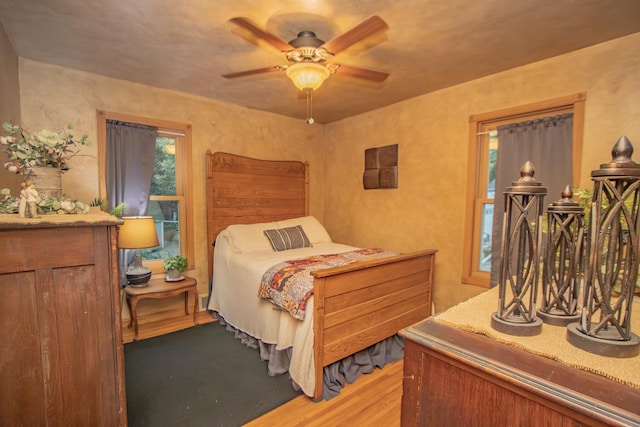 bedroom with a ceiling fan and wood finished floors