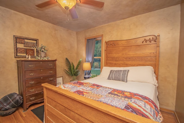 bedroom with a ceiling fan and wood finished floors