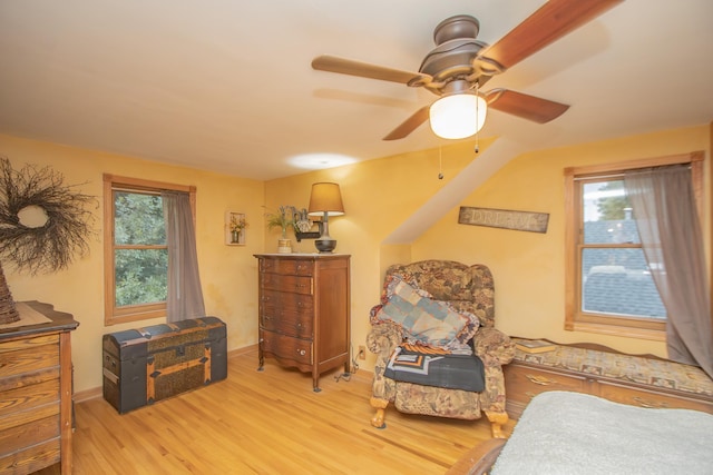 sitting room with a wealth of natural light, light wood-style flooring, and ceiling fan