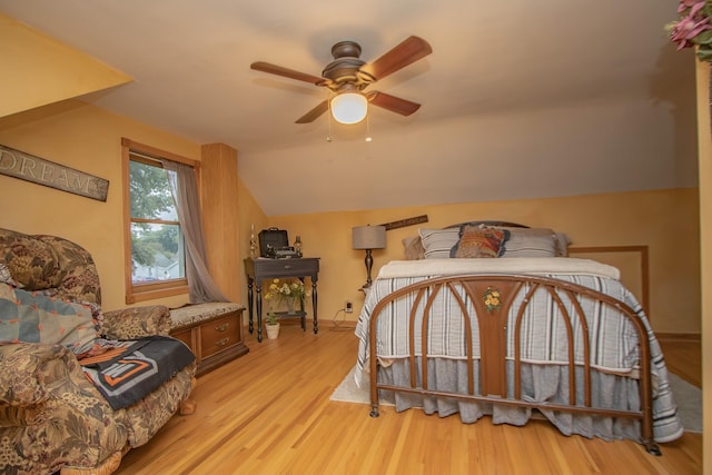 bedroom with light wood-type flooring, baseboards, ceiling fan, and vaulted ceiling