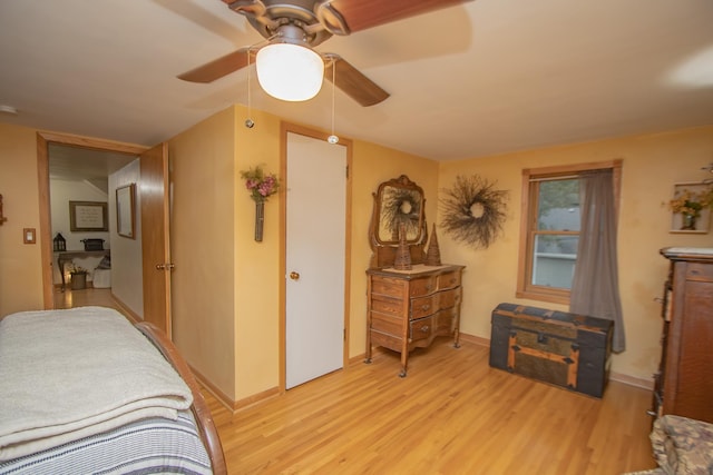 bedroom with baseboards, light wood-style flooring, and a ceiling fan