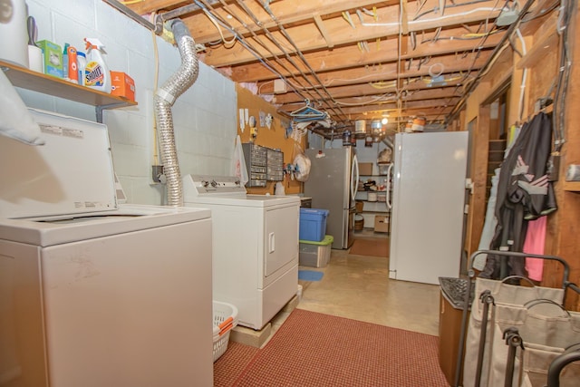 laundry area featuring washer and dryer, concrete block wall, and laundry area