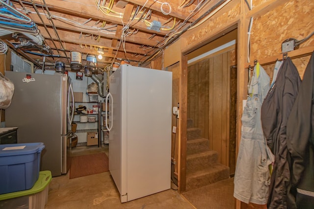 unfinished below grade area with stairway and freestanding refrigerator