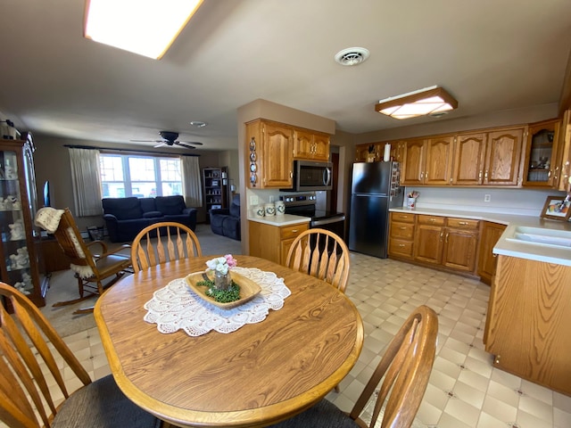 dining room with visible vents, light floors, and a ceiling fan