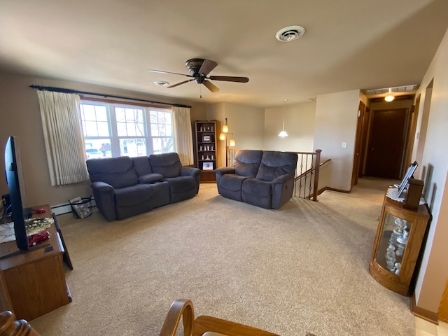 living room with visible vents, light carpet, baseboards, and ceiling fan