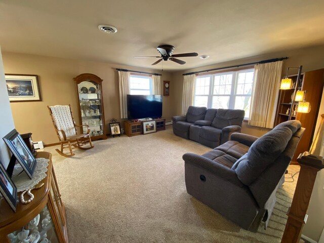 living room with visible vents, baseboards, carpet, and a ceiling fan