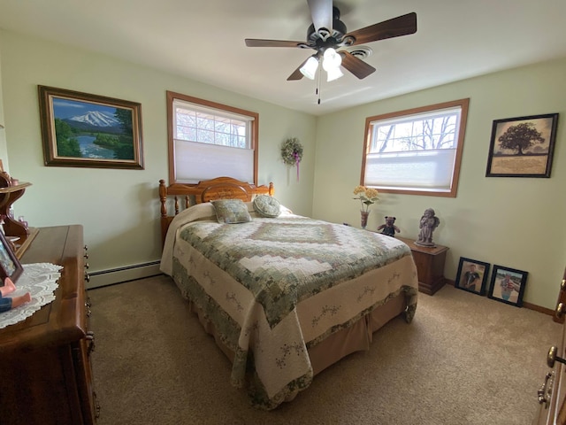 bedroom with multiple windows, light colored carpet, ceiling fan, and a baseboard radiator