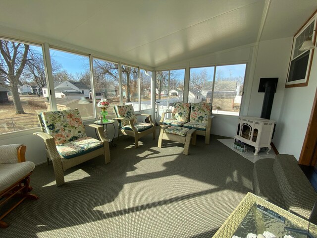 sunroom featuring vaulted ceiling and heating unit