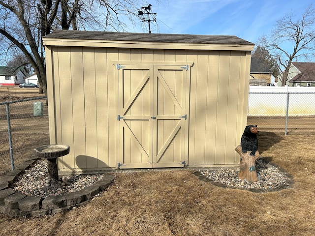 view of shed with fence