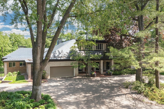 5123 Lake Ridge Rd, Edina, MN 55436 - view of front facade featuring driveway, brick siding, and an attached garage