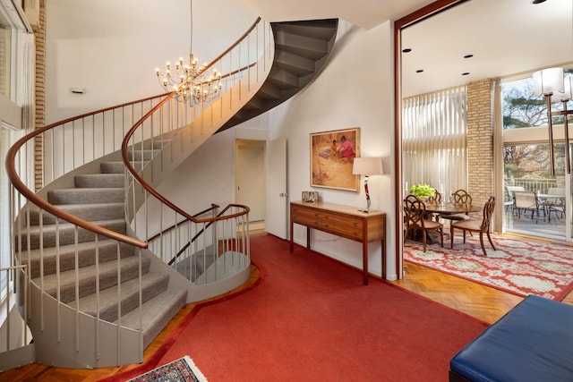 5123 Lake Ridge Rd, Edina, MN 55436 - stairway with a towering ceiling and a chandelier