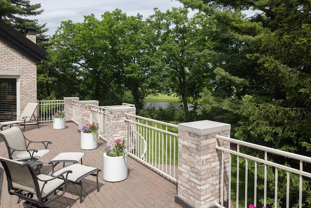 5123 Lake Ridge Rd, Edina, MN 55436 - view of patio / terrace with view of wooded area, a water view, and a balcony