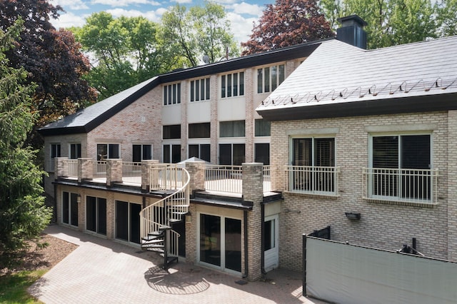 5123 Lake Ridge Rd, Edina, MN 55436 - back of house with brick siding, a chimney, a patio area, and stairway