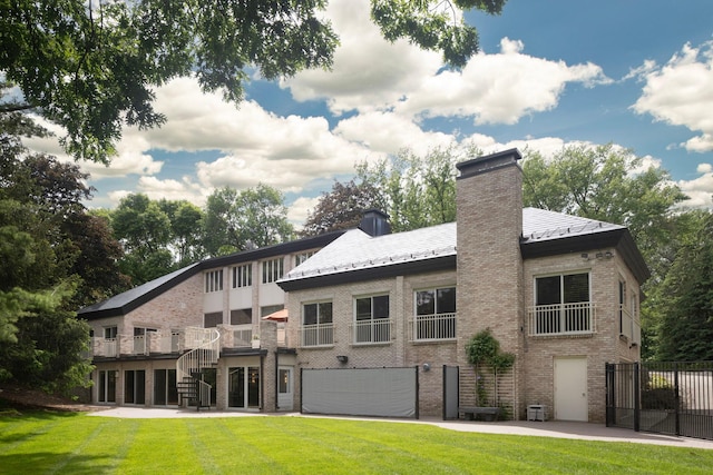 5123 Lake Ridge Rd, Edina, MN 55436 - rear view of property with stairs, brick siding, a chimney, and a garage