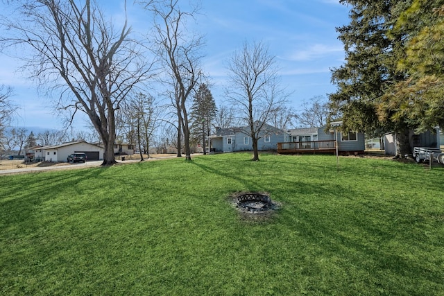 view of yard with an outdoor fire pit and a deck