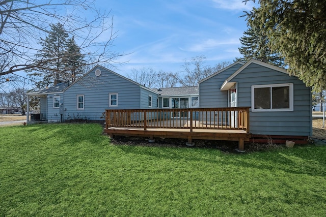 rear view of property with a yard and a wooden deck