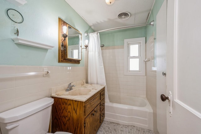 full bathroom with visible vents, toilet, shower / bath combination with curtain, tile walls, and tile patterned flooring