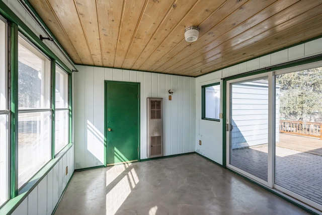 unfurnished sunroom with wooden ceiling and a healthy amount of sunlight